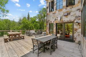Wooden terrace with outdoor dining area and outdoor lounge area