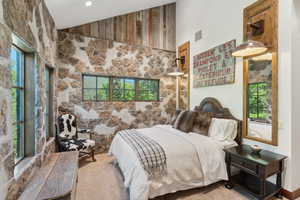 Carpeted bedroom featuring vaulted ceiling