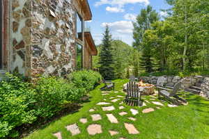 View of green lawn with an outdoor fire pit