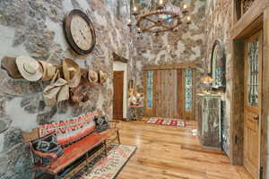 Foyer entrance featuring a chandelier and hardwood / wood-style floors