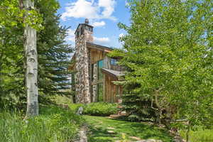 View of property exterior with a chimney