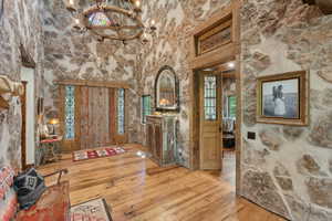 Entryway featuring a chandelier, hardwood / wood-style flooring, and healthy amount of natural light
