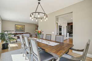 Dining area with light wood-style flooring, recessed lighting, and a chandelier