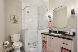 Full bath with vanity and a shower stall
