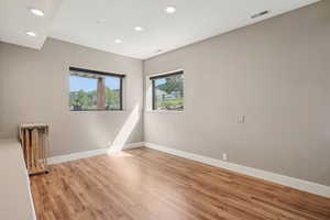 Unfurnished room with recessed lighting and light wood-style floors