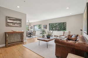 Living room featuring light wood finished floors, plenty of natural light, and recessed lighting