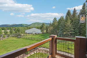 Wooden deck with a mountain view and a view of rural / pastoral area
