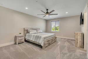 Bedroom with light carpet, recessed lighting, and a ceiling fan