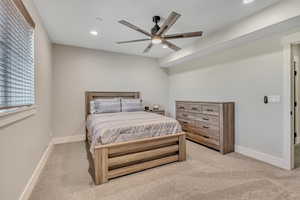 Bedroom featuring light colored carpet, recessed lighting, and a ceiling fan