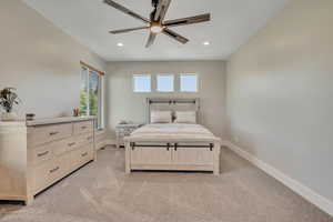 Bedroom featuring light colored carpet, recessed lighting, and ceiling fan