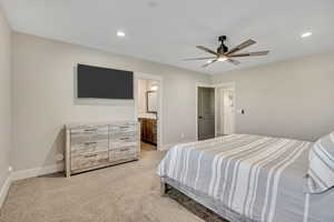 Bedroom featuring recessed lighting, light carpet, connected bathroom, and ceiling fan