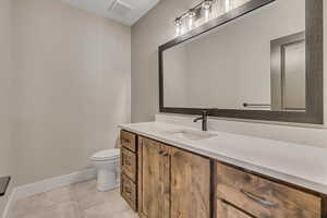Bathroom featuring baseboards and vanity