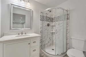 Bathroom with vanity and a shower stall