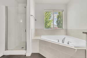 Full bathroom featuring a shower stall and a garden tub