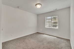 Spare room with carpet flooring and a smoke detector