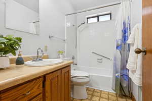Bathroom with shower / bath combo and vanity