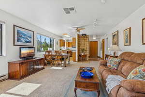 Living room featuring light colored carpet and ceiling fan
