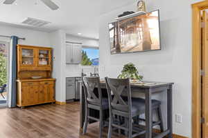 Dining room with a ceiling fan, dark wood-style floors, and recessed lighting