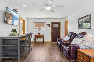 Living area featuring wood finished floors, a ceiling fan, and recessed lighting