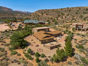 Aerial view of property and surrounding area featuring a mountain backdrop