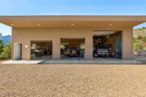 Garage featuring a mountain view and driveway