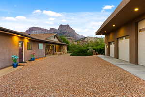 View of property exterior featuring a mountain view and a garage
