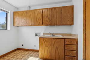 Washroom featuring cabinet space, washer hookup, and hookup for an electric dryer