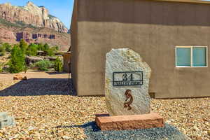 Exterior view of stucco siding and a mountainous background