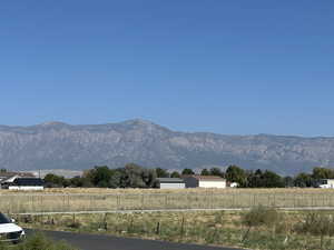 View of mountain backdrop featuring rural landscape
