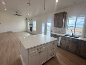Kitchen with white cabinets, recessed lighting, pendant lighting, dark wood-style floors, and a kitchen island