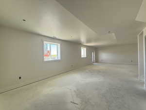 Spare room featuring a textured ceiling and unfinished concrete floors