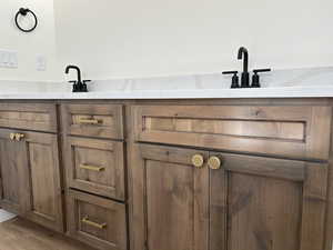 Bathroom view of double vanity and wood finished floors