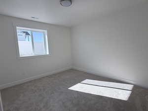 Unfurnished room with carpet flooring and baseboards