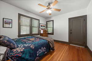 Bedroom with wood finished floors and a ceiling fan