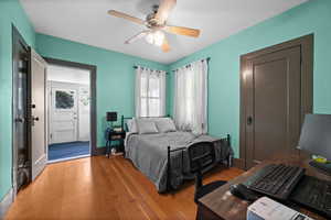 Bedroom with light wood finished floors and ceiling fan