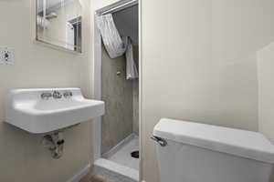 Full bath with a shower stall and toilet