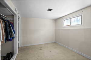 Empty room with carpet flooring and baseboards