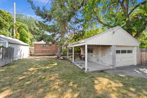 Fenced backyard with a detached garage