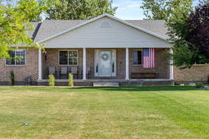 Front entrance and porch featuring brick exterior