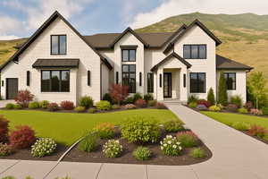 Modern farmhouse style home featuring stone siding, a mountain view, and a front yard