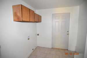 Laundry room with cabinet space and hookup for a washing machine & electric dryer