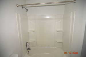 Full bathroom featuring bathing tub / shower combination, sink and toilet