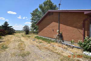 View of side of home with brick siding