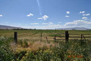 View of yard with a rural view and a mountain view