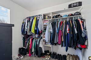 Walk in closet with carpet floors