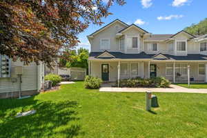 View of front of home with a porch and roof with shingles