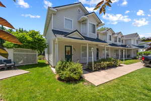 View of front of house featuring a front lawn and covered porch