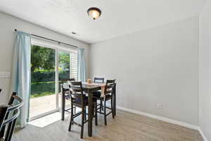 Dining area with wood finished floors and a textured ceiling