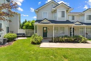 Multi unit property with a shingled roof and covered porch