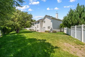Rear view of property featuring a chimney